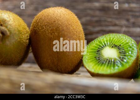 Kiwi fruits in natura and in halves. Kiwi or Kiwi (Actinidia delicious) is a fruit of the Actinidiaceae family. Its name is a tribute to the national Stock Photo