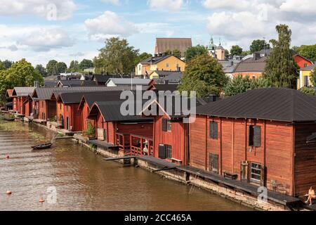 Old red-ocher log storage building on riverbank of Porvoonjoki in Old Town Porvoo, Finland Stock Photo