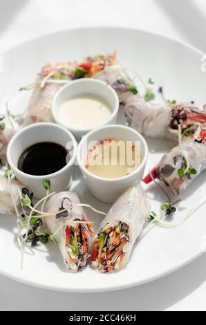 asian fresh vegetable vegan spring rolls with sauces in vietnam Stock Photo
