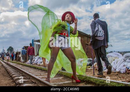 Nairobi, Kenya. 11th Dec, 2021. A young female model dressed in a colorful  outfit poses by the streets during the Mr. and Mrs. Kibera modeling contest  in Kibera Slums. Young models and