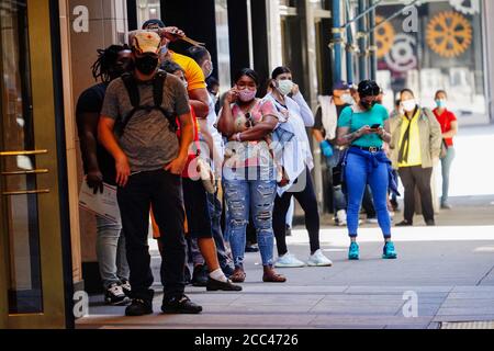 New York, USA. 27th May, 2020. People wearing face masks queuing at Paramount Theater, Times Square during the coronavirus crisis.Government guidelines encourage wearing face masks in public with strong social distancing in effect as all 50 states in the USA have begun a gradual process to slowly reopen after weeks of stay-at-home measures to slow the spread of COVID-19. Credit: John Nacion/SOPA Images/ZUMA Wire/Alamy Live News Stock Photo