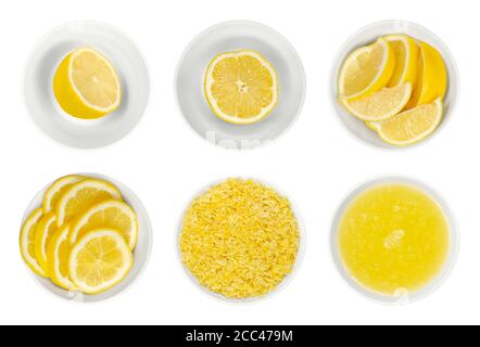 Fresh lemons, cut in half, slices and wedges, lemon zest and juice in white glass bowls. Ripe and yellow citrus fruits, used for culinary and cleaning Stock Photo