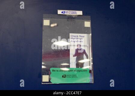Goleta, California, USA. 17th Aug, 2020. The sign, 'Check Your Mail From Anywhere: We are Always Open: United States Postal Service' is ironic, since the 24 hour accessible outdoor mailbox on Patterson Ave. in Goleta was removed on August 16. This pamphlet is on the door to the Post MasterÃs office, inside the Goleta Post Office, where customers have to come inside to put their mail, since the one outside that they could drive up to in their cars was removed.The Patterson location is one of Santa Barbara CountyÃs busiest post offices, with thousands of people dropping off mail a day. Stock Photo