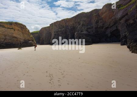 View of the impressive cliffs and the beach discovered in low sea. Las Catedrales beach, Galicia, Spain Stock Photo