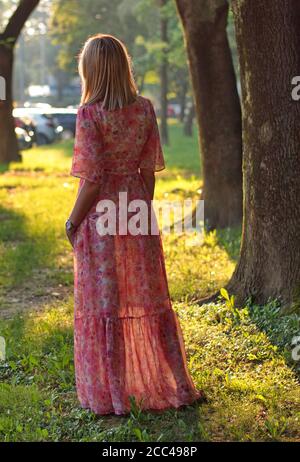 Portrait of mature woman in a park against the morning sun Stock Photo