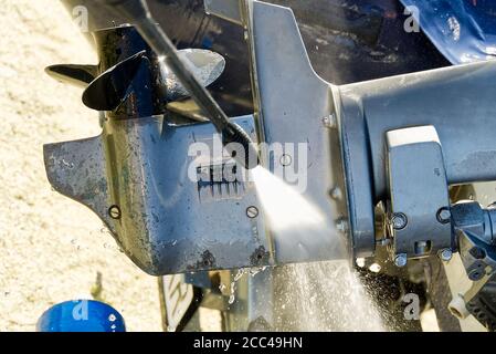washing service of outboard motor by pressure. selective focus. Stock Photo