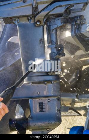 washing service of outboard motor by pressure. selective focus. Stock Photo