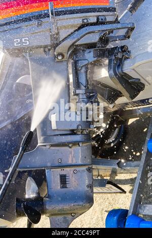 washing service of outboard motor by pressure. selective focus. Stock Photo