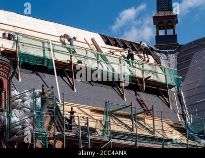 Roofers at work on a roof Stock Photo