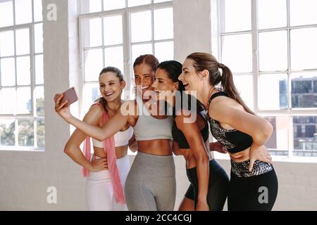 Friends making selfie in the gym after workout Stock Photo - Alamy
