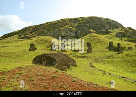 Many of Travelers Visiting the Large Groups of Abandoned and Unfinished Gigantic Moai Statue Ruins on the Slope of Rano Raraku Volcano, Easter Island Stock Photo