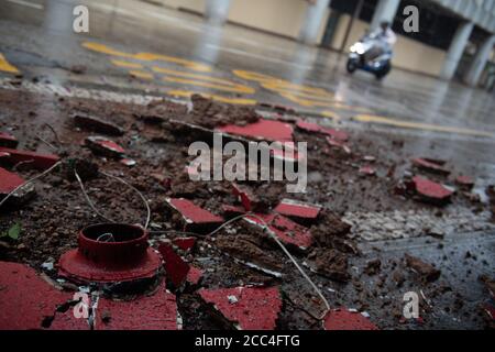 (200819) -- MACAO, Aug. 19, 2020 (Xinhua) -- A motorcyclist rides past building debris on a road in Macao, south China, Aug. 19, 2020. China's Macao Special Administrative Region has downgraded its typhoon signal from highest No.10 level to No.8 on Wednesday at 7:30 a.m. local time, but the low-lying areas near the coastline were flooded, as Typhoon Higos had made landfall in the neighboring city of Zhuhai in the morning. Credit: Xinhua/Alamy Live News Stock Photo