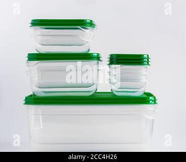 Empty plastic food containers are stacked on a white background. Stock Photo