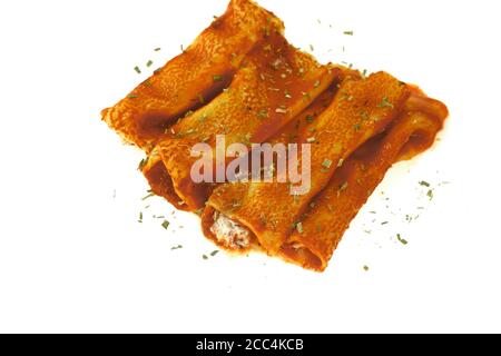 Canelones Italian Dish Bolognese with cheese and bechamel sauce. Delicious meat filled pasta on a plate on white background. Italian cannelloni Stock Photo