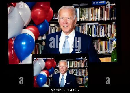 (200819) -- WASHINGTON, Aug. 19, 2020 (Xinhua) -- U.S. Democratic presidential nominee and former Vice President Joe Biden reacting in a video feed from Delaware is displayed on screens in Arlington, Virginia, the United States, on Aug. 18, 2020.  The ongoing U.S. Democratic National Convention (DNC) on Tuesday voted to officially nominate Joe Biden as the party's presidential candidate. (Xinhua/Liu Jie) Stock Photo