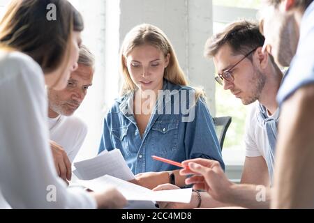 Young business professionals having a meeting. Diverse group of young designers smiling during a meeting at the office. Stock Photo