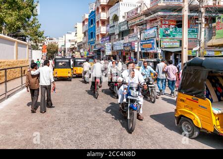 PUTTAPARTHI, INDIA - JANUARY 13, 2013: People on the main street of Puttaparthi vilagge, in Anantapur district of Andhra Pradesh, India. Stock Photo