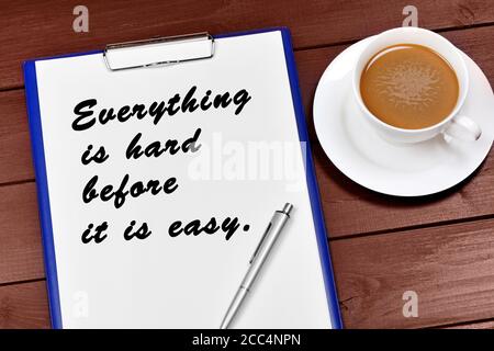 Everything is hard before it is easy written on paper. Motivational quote Stock Photo