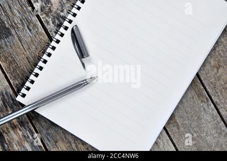 Close up of empty notebook with pen on a wooden table Stock Photo