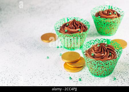 Chocolate cupcakes with green sugar sprinkles with copy space Stock Photo