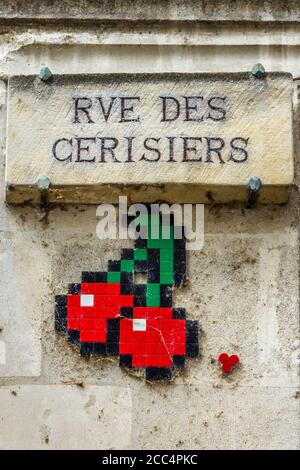 Ceramic mosaic "Red Cherries" symbol created by street artist 'Invader' in Rue des Cerisiers (Cherry Street / Road), Tours, Indre-et-Loire, France. Stock Photo