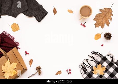 Autumn composition -  suede bag, cosy clothes, autumn leaves and coffee isolated on white background, flat lay, top view, copy space. Seasonal autumn Stock Photo