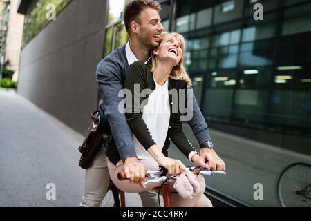 Beautiful happy couple in love on bicycle in the city Stock Photo