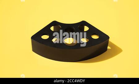 Plastic stand for tattoo ink caps on yellow background Stock Photo
