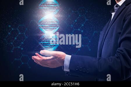 Genetic technologies concept. Collage with businessman holding DNA helix over blue background Stock Photo