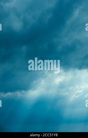 Sunrays Through Blue Rainy Dramatic Sky. Natural Abstract Background Stock Photo