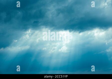 Sunrays Through Blue Rainy Dramatic Sky. Natural Abstract Background Stock Photo