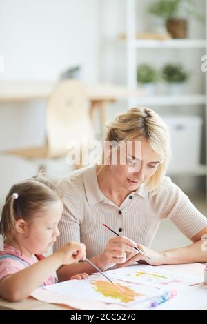 Two preschool girls playing and coloring pictures in rehabilitation ...