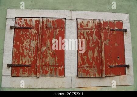 Windows with closed shutters in the old house Stock Photo