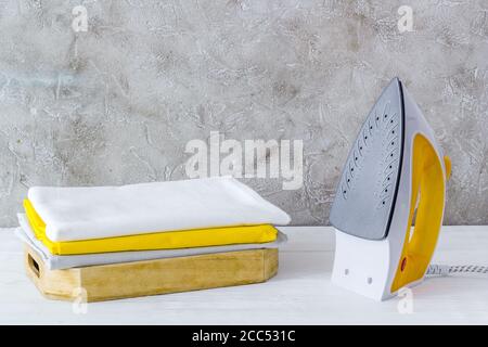Close up of iron and towels on ironing board Stock Photo