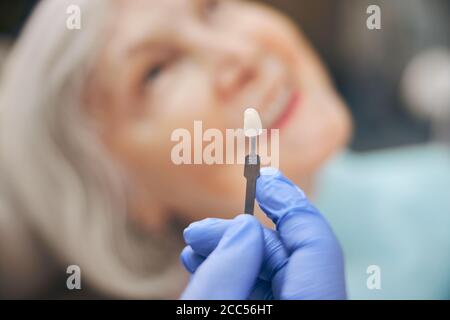 Doctor demonstrating new color palette teeth for patient Stock Photo