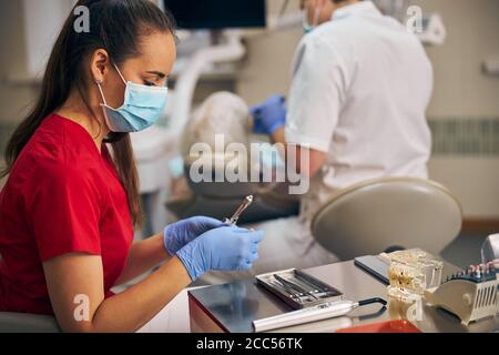 Beautiful nurse is preparing anesthesia for patient Stock Photo