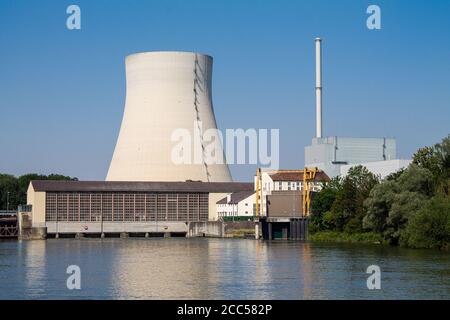 Three locks of a hydropower plant with a machine house. And a cooling tower of a nuclear power plant in the background. Stock Photo