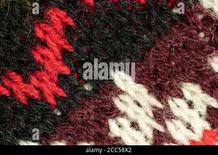 Black, red and white fur tissue texture. Wool cloth background Stock Photo