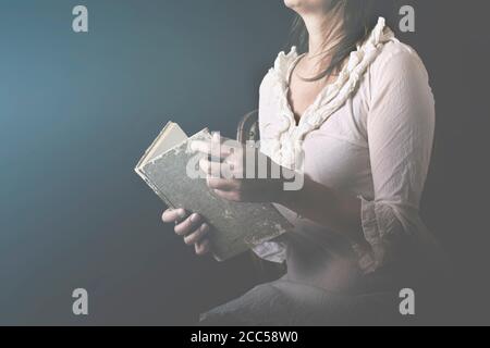 dreaming woman reads the pages of a book with love Stock Photo