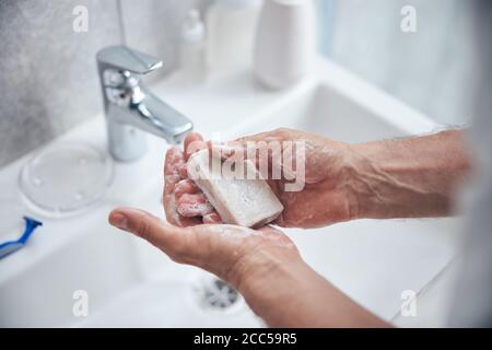 Male taking care of his hand hygiene Stock Photo