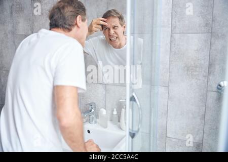 Adult Caucasian male wrinkling up his forehead Stock Photo