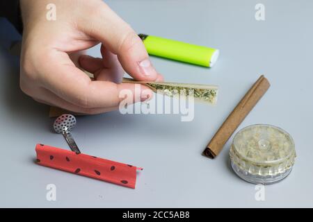 Grinder, lighter and smoking paper for cannabis medical use. Healthcare and  THC. Marijuana treatment of anxiety. Copy space near weed jar Stock Photo -  Alamy