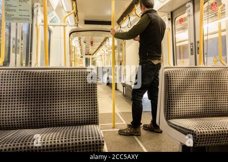 Man standing on an empty Metro train. UK Stock Photo