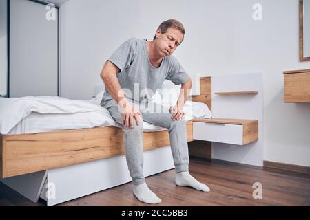 Worried mature man being at home alone Stock Photo
