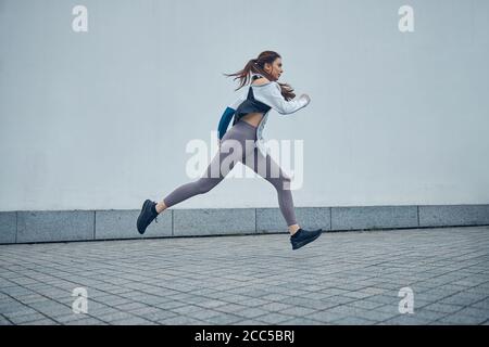 Fit young Caucasian lady moving in midair Stock Photo