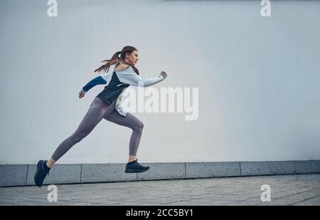 Active young Caucasian woman captured in motion Stock Photo