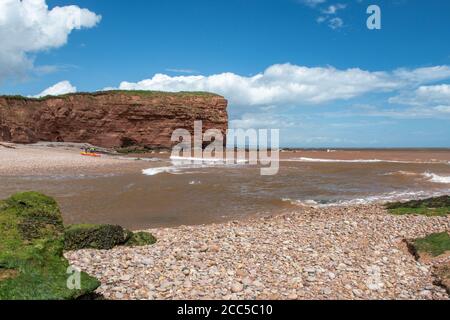Landscape photo of the the mouth of the Otter estuary flowing into the sea on Budleigh Salterton beach Stock Photo