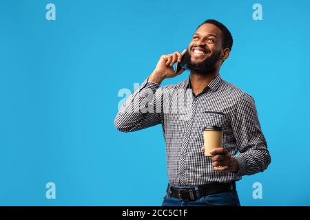 Smiling black man talking on the phone at studio Stock Photo