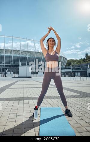 Fit female stretching with her eyes closed Stock Photo