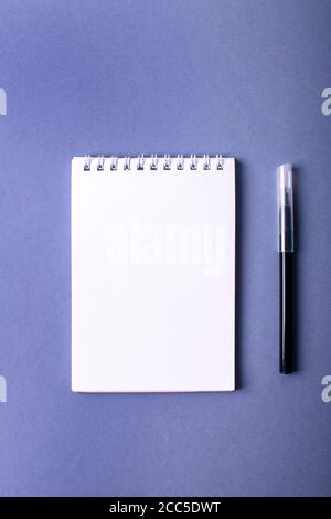 Open notebook with black marker on a violet background. Stock Photo